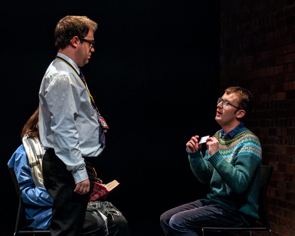 Photo of 7 CARRIAGES with two students on stage