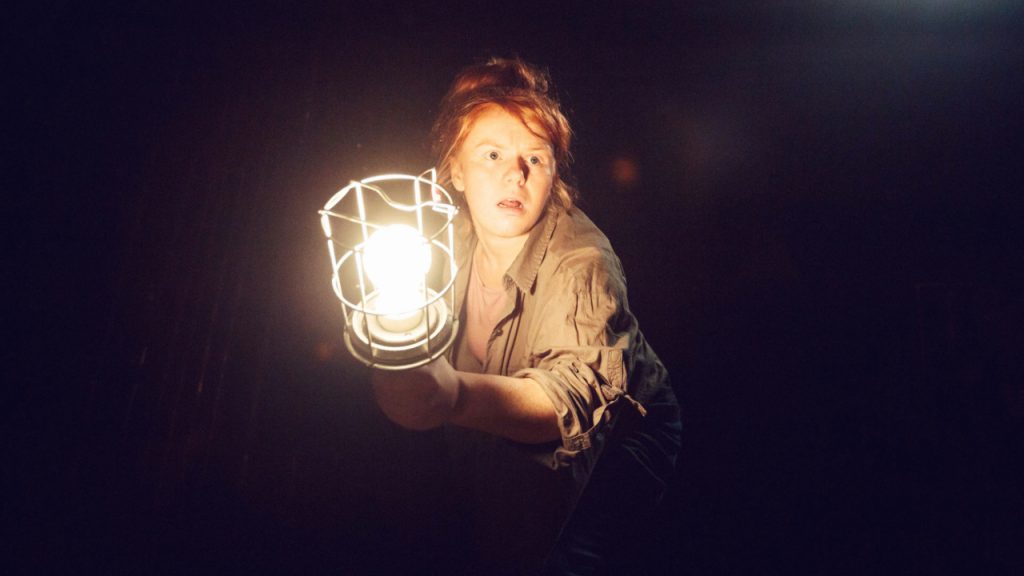 JoAnne Haines holds a light in A Little Space